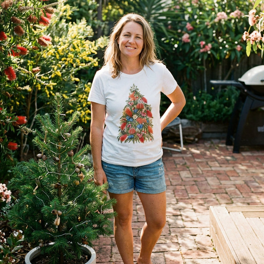 White t-shirt with a Christmas tree made from Australian native flowers including banksia, bottlebrush and flannel flowers.