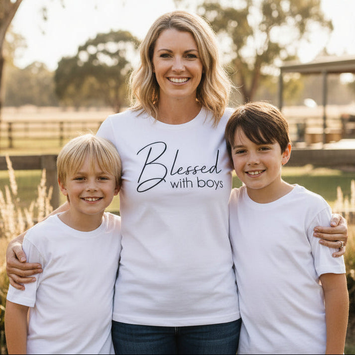 Woman wearing Blessed With Boys shirt smiling outdoors, Mother’s Day gift idea