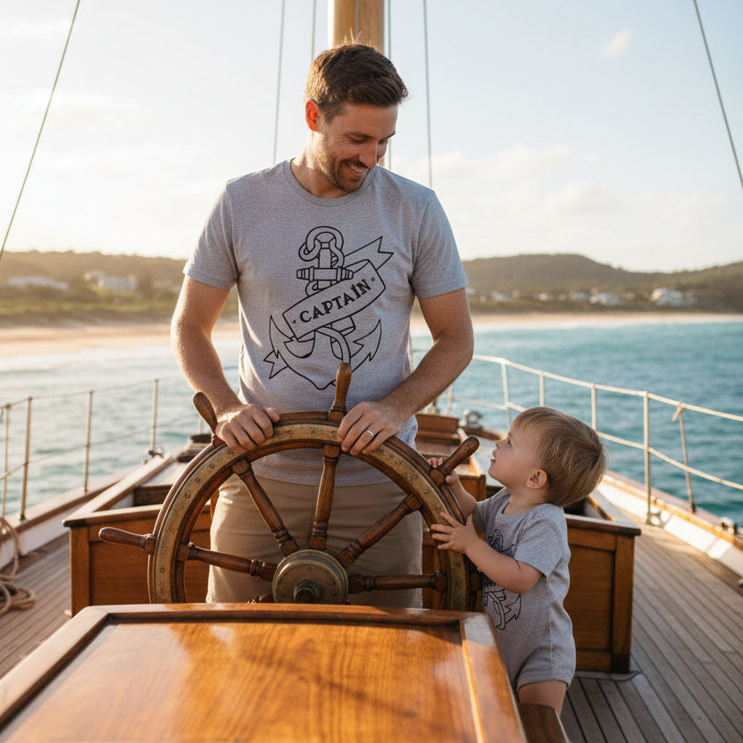 Grey t-shirt reading Captain and grey baby bodysuit reading First Mate, both with a navy tattoo-style anchor and banner.