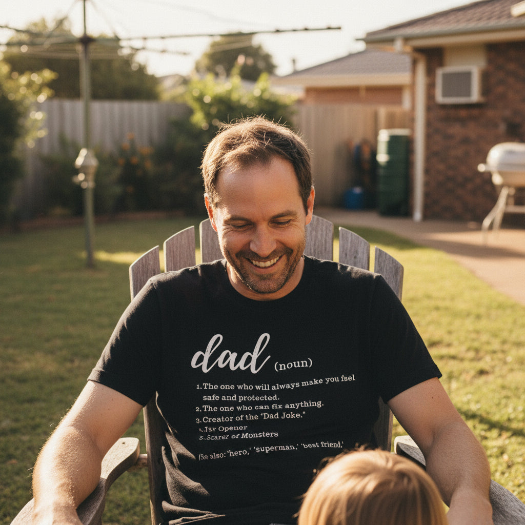 Black t-shirt with a dictionary style definition of the word dad listing five qualities in white lettering.