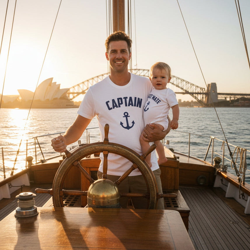 White t-shirt reading Captain and white baby bodysuit reading First Mate, both with a navy anchor.