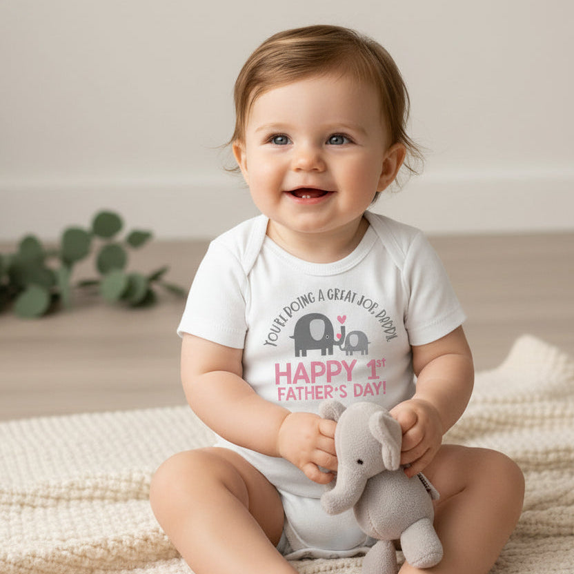 White baby bodysuit with an elephant and calf design reading You're Doing A Great Job Daddy, Happy 1st Father's Day, and the year.