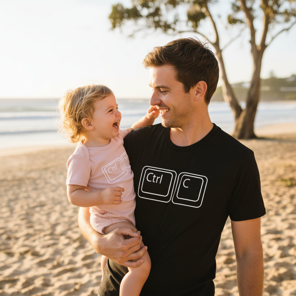black t-shirt printed with Ctrl C keys beside a pink baby bodysuit printed with Ctrl V keys.