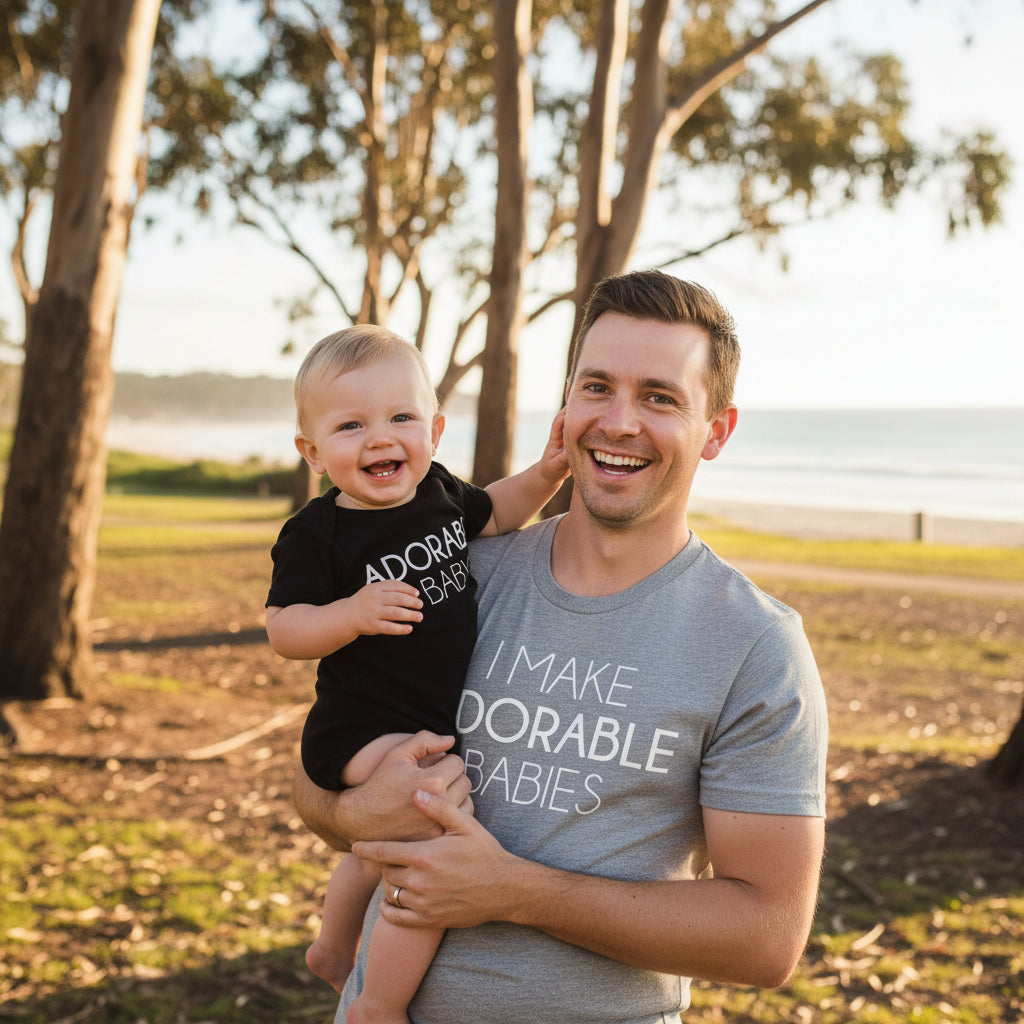 Grey adult t-shirt reading I Make Adorable Babies and black baby bodysuit reading Adorable Baby.