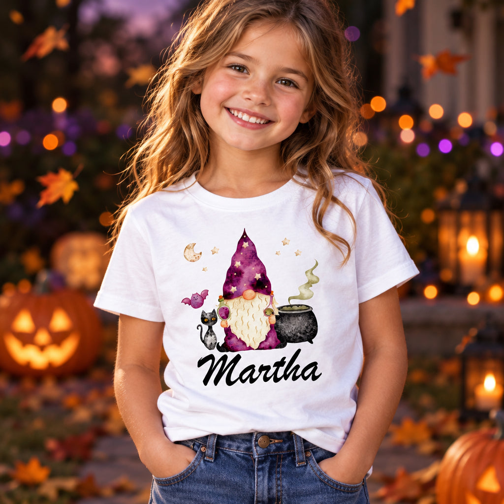 White kids t-shirt with Halloween gnome in starry wizard hat, cauldron, black cat and bat, personalised with name "Martha"
