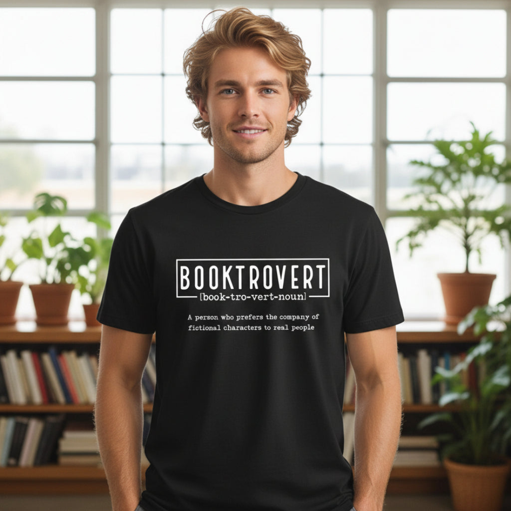 Woman holding books wearing a cream Booktrovert t-shirt with dictionary-style definition design about preferring fictional characters to real people