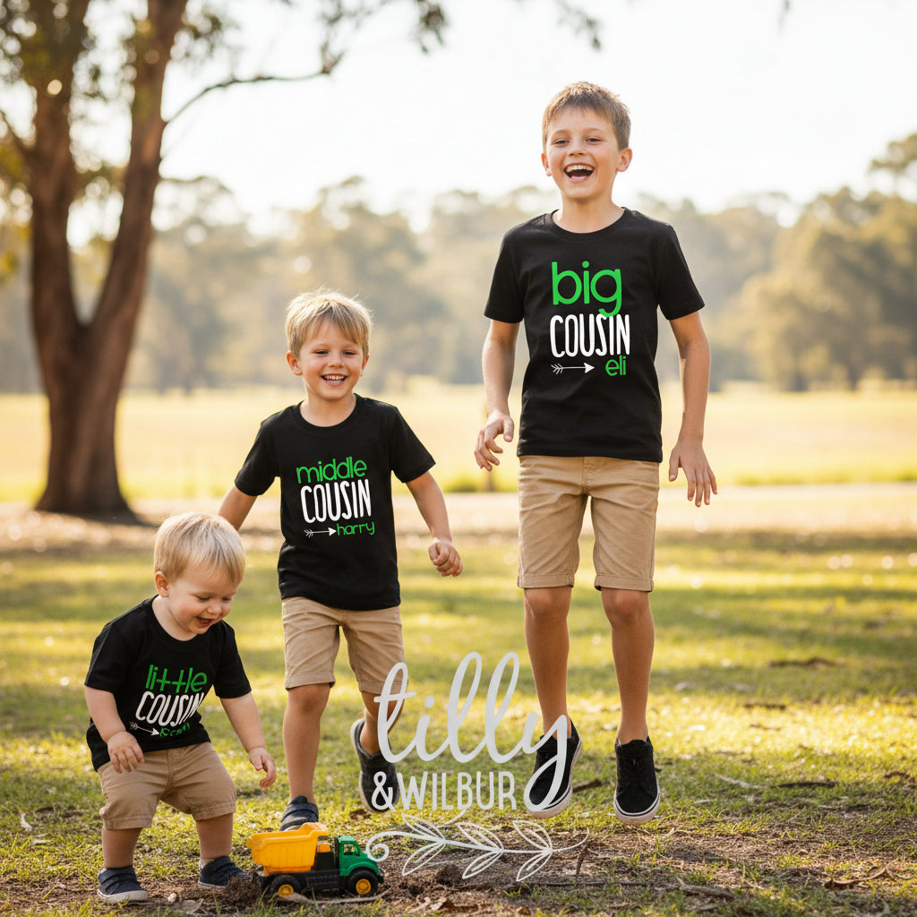 Three black kids t-shirts reading Big Cousin, Middle Cousin and Little Cousin with personalised names.