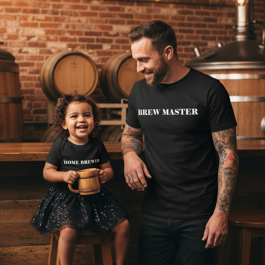 Dad and daughter at a brewery in matching black tops that read Brew Master and Home Brewed.