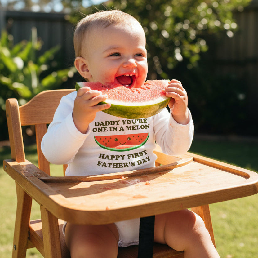 White baby bodysuit with a smiley watermelon and text reading Daddy You're One In A Melon, Happy First Father's Day.