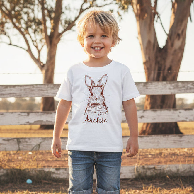 Personalised minimal bunny Easter shirt with custom name in script font on kids white shirt