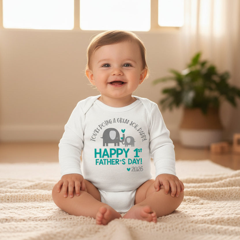 White baby bodysuit with a teal elephant and calf design reading You're Doing A Great Job Daddy, Happy 1st Father's Day, and the year.