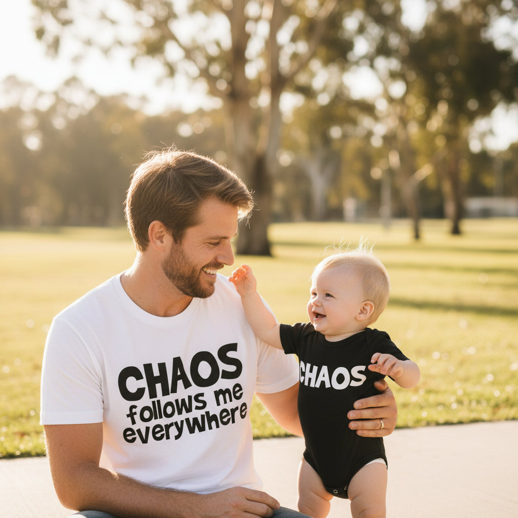 White t-shirt reading Chaos Follows Me Everywhere beside a black baby bodysuit reading Chaos.