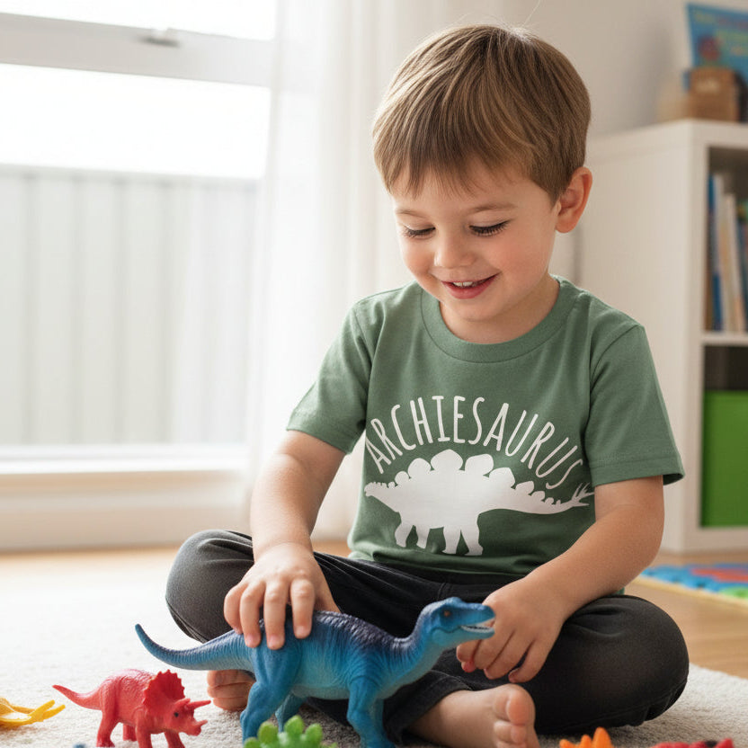 Personalised dinosaur kids shirt with custom name and stegosaurus design in sage green