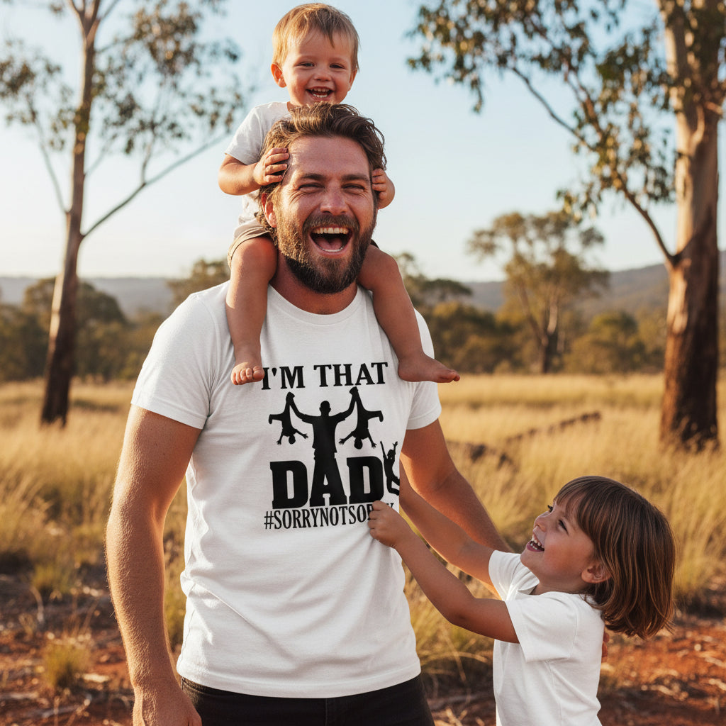 White t-shirt with a dad swinging two kids design reading I'm That Dad #SorryNotSorry.