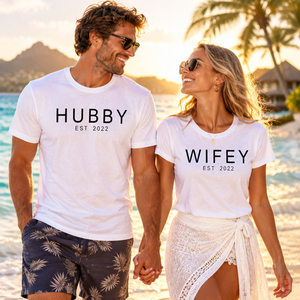 Matching black Hubby and Wifey t-shirt set with personalised Est year text, worn by couple