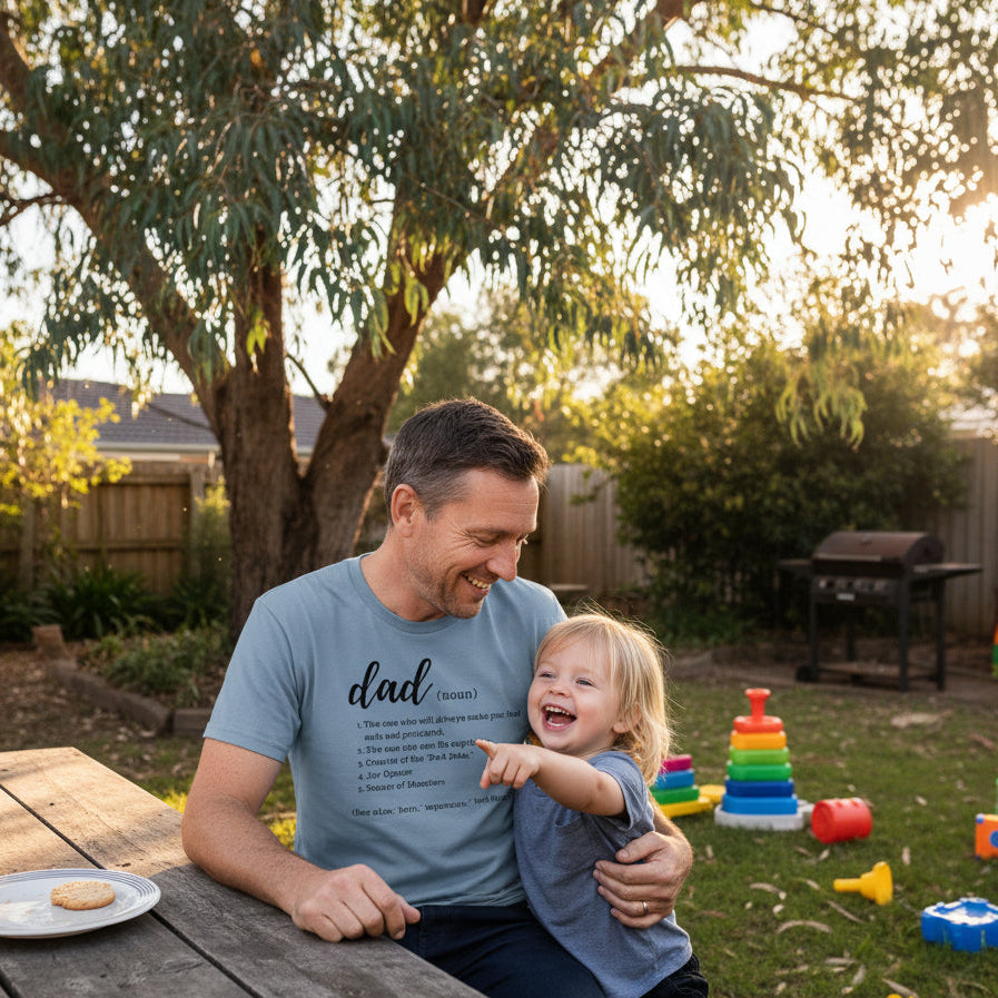 Blue t-shirt with a dictionary style definition of the word dad listing five qualities in white lettering.