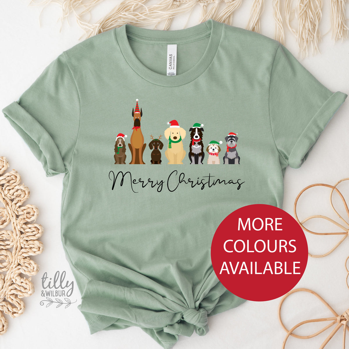 A green Merry Christmas dog T-shirt with illustrations of dogs wearing Christmas hats and text.