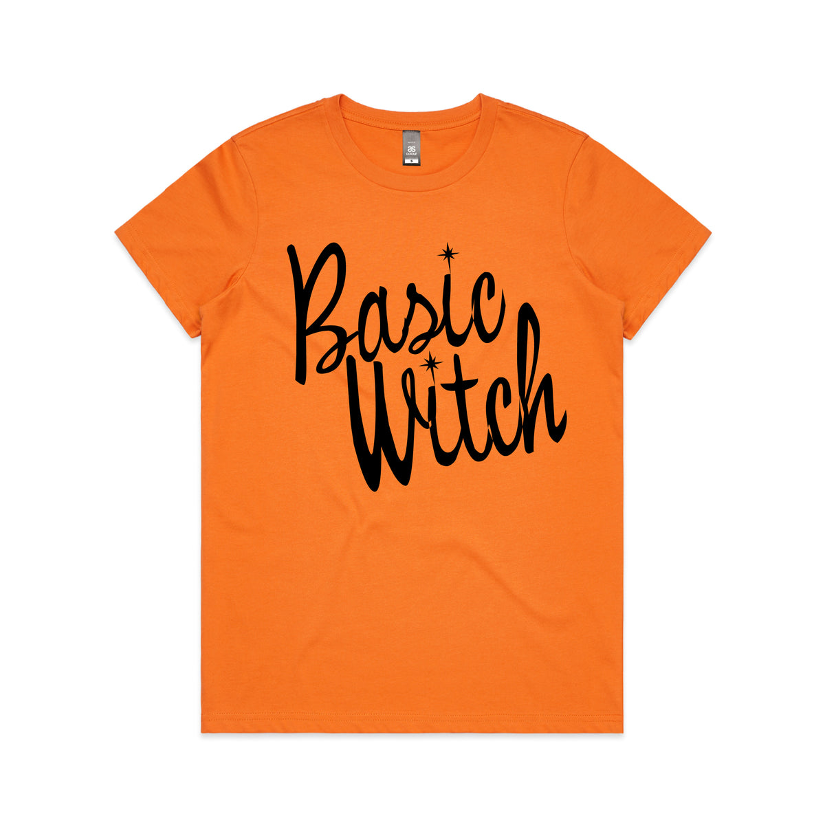 An orange short-sleeve crewneck t-shirt featuring the words 'Basic Witch' printed in a black cursive font with small star accents, displayed flat against a white background.