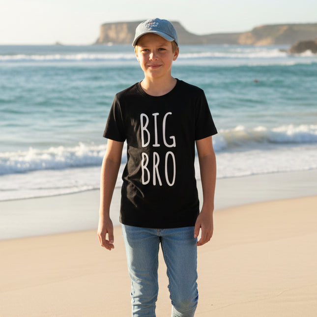 Toddler wearing black Big Bro shirt outdoors