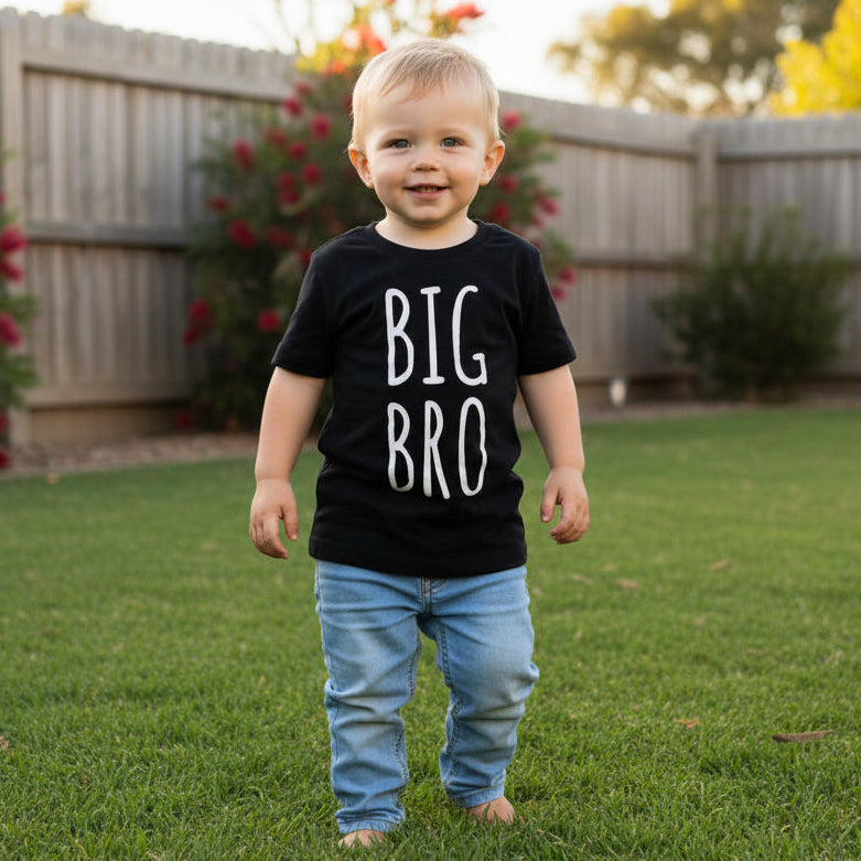 Toddler wearing black Big Bro shirt outdoors