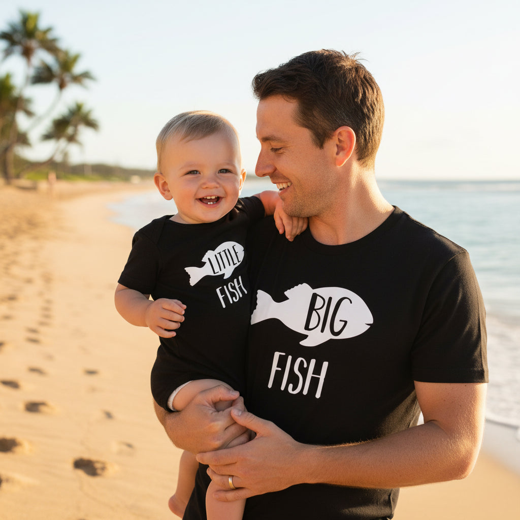 Tilly&Wilbur white matching set — an adult tee printed with "Big Fish" and a baby bodysuit printed with "Little Fish," each with a black fish graphic.
