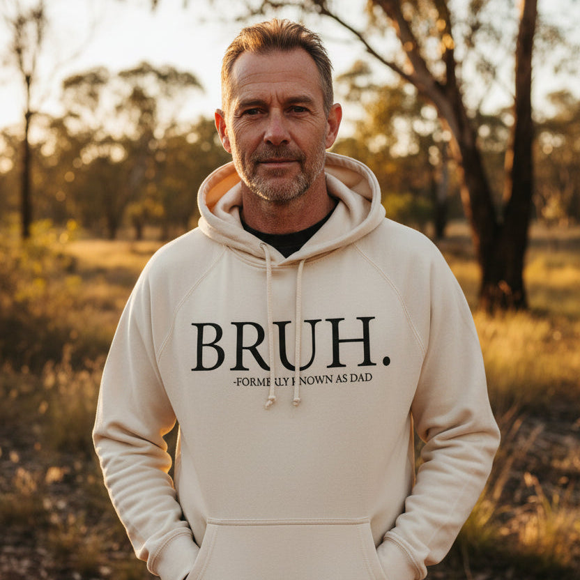 Man wearing a ecru hoodie that reads Bruh, formerly known as Dad.