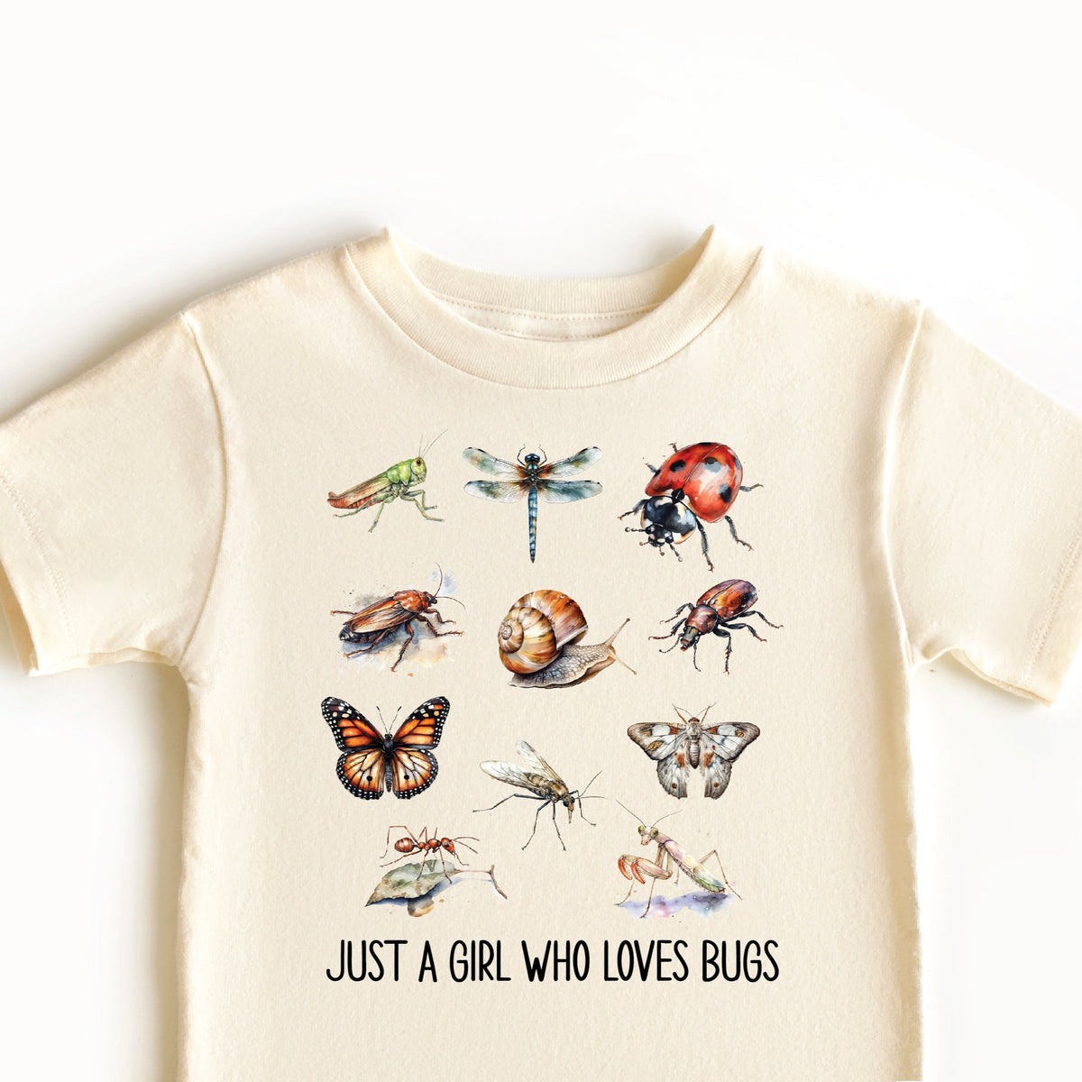 A beige t-shirt with a graphic print of various insects and the text 'Just a girl who loves bugs'.