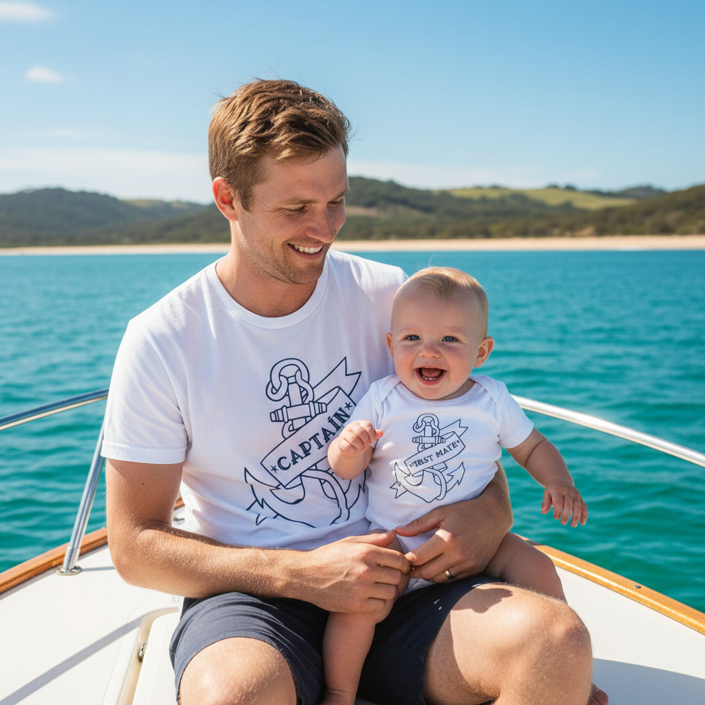White t-shirt reading Captain and white baby bodysuit reading First Mate, both with a navy tattoo-style anchor and banner.