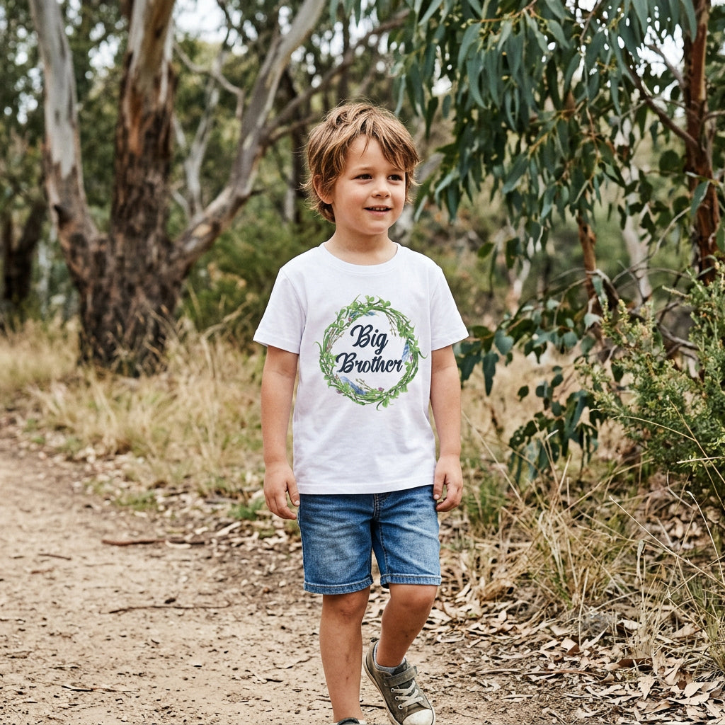 A white short-sleeve t-shirt featuring a circular floral wreath graphic with green leaves and blue/purple flowers, enclosing the text 'Big Brother' in black script. 