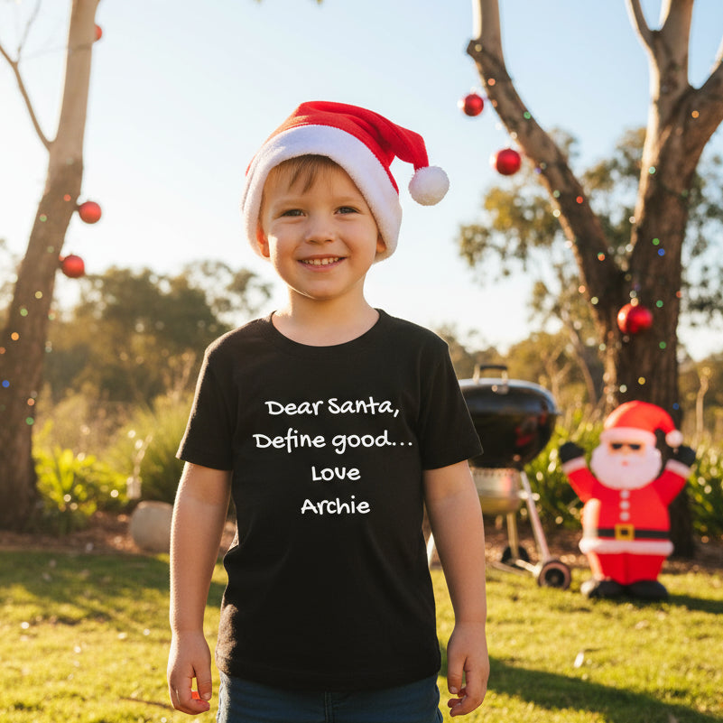 A black short-sleeved T-shirt with the text 'DEAR SANTA, DEFINE GOOD... LOVE... ARCHIE' printed on the front.