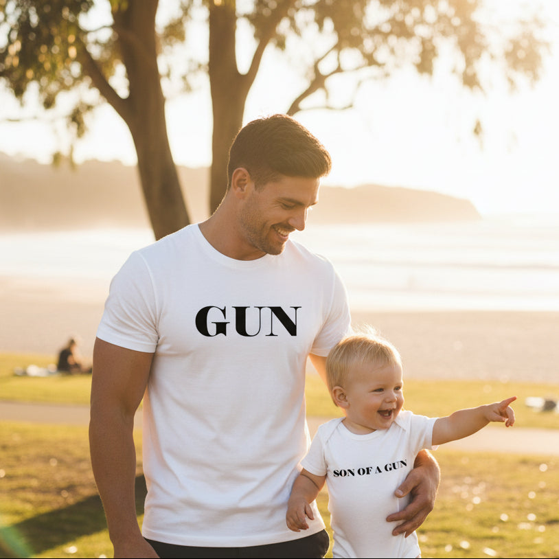 White adult t-shirt reading Gun and a white baby bodysuit reading Son Of A Gun.