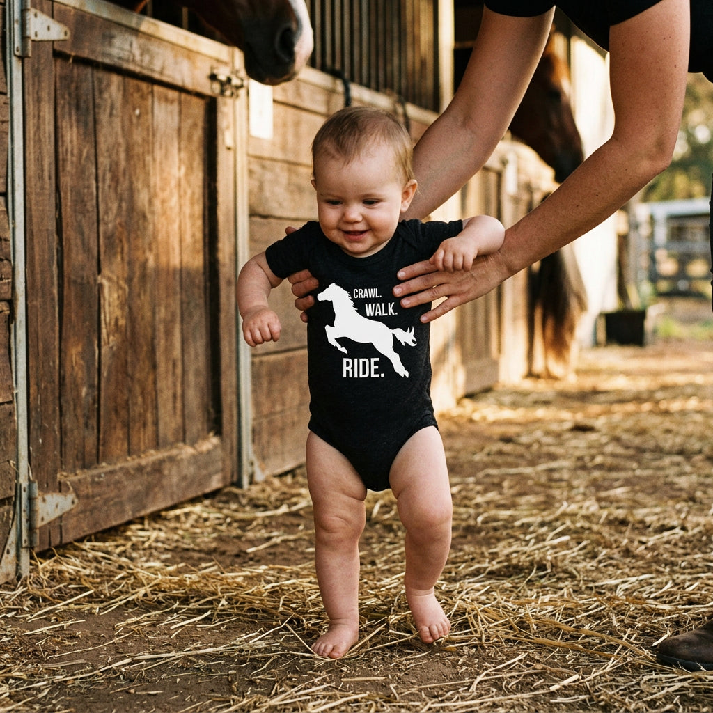Baby bodysuit with a galloping horse silhouette and the words Crawl Walk Ride.