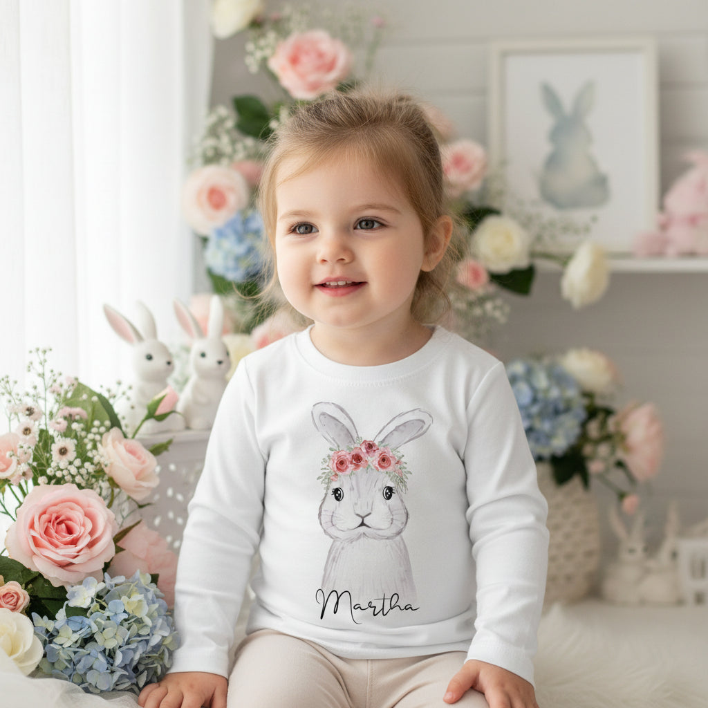 Personalised Easter bunny shirt with floral crown and custom name for baby girl sitting in pastel floral setting