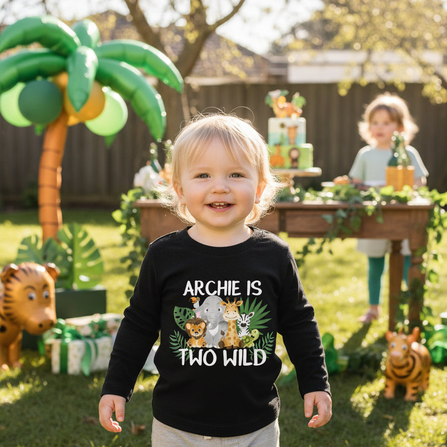 Black kids long sleeve tee with safari animals and a personalised name above Two Wild.
