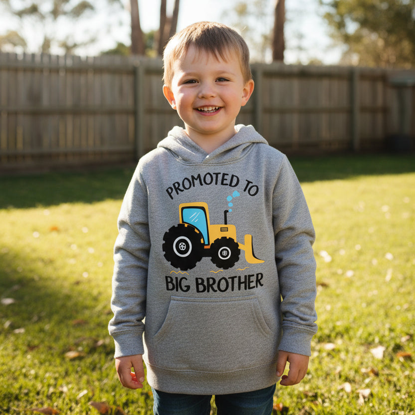 Grey kids hoodie with bright yellow tractor design and Promoted To Big Brother lettering