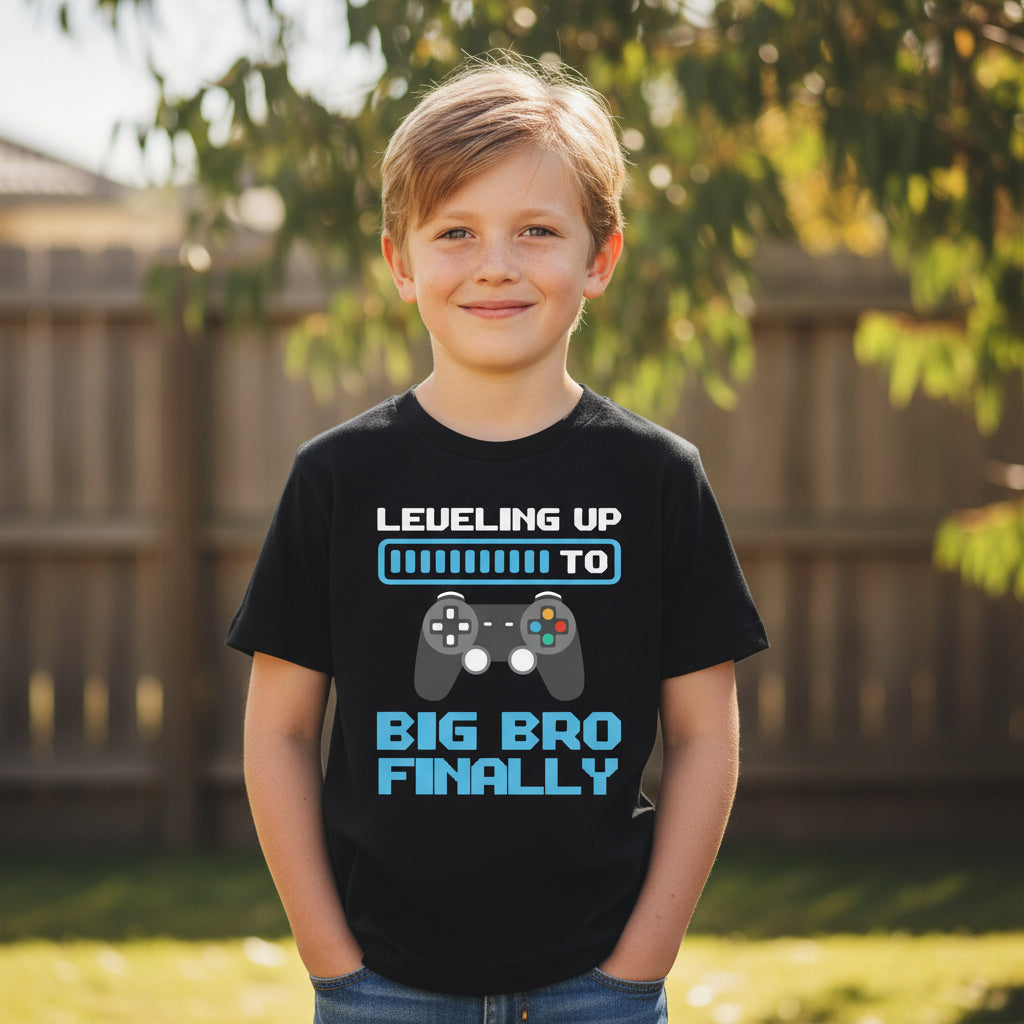 Boy wearing a black t-shirt with a gaming controller design that reads Levelling Up To Big Bro Finally.
