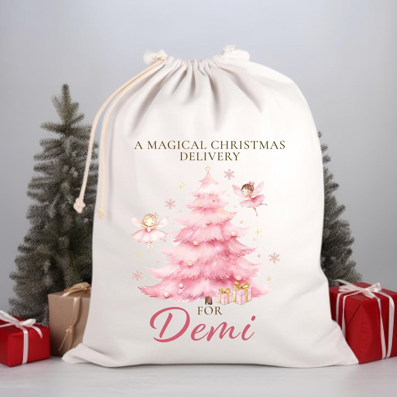 White drawstring bag with Christmas design and text, placed on a gray surface with decorative elements.