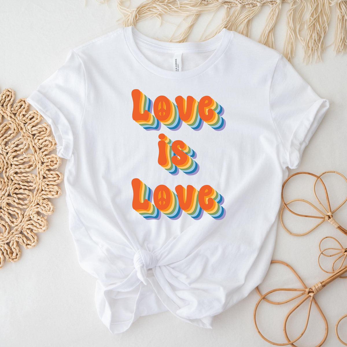 White t-shirt with 'Love is Love' in colorful letters on a light background