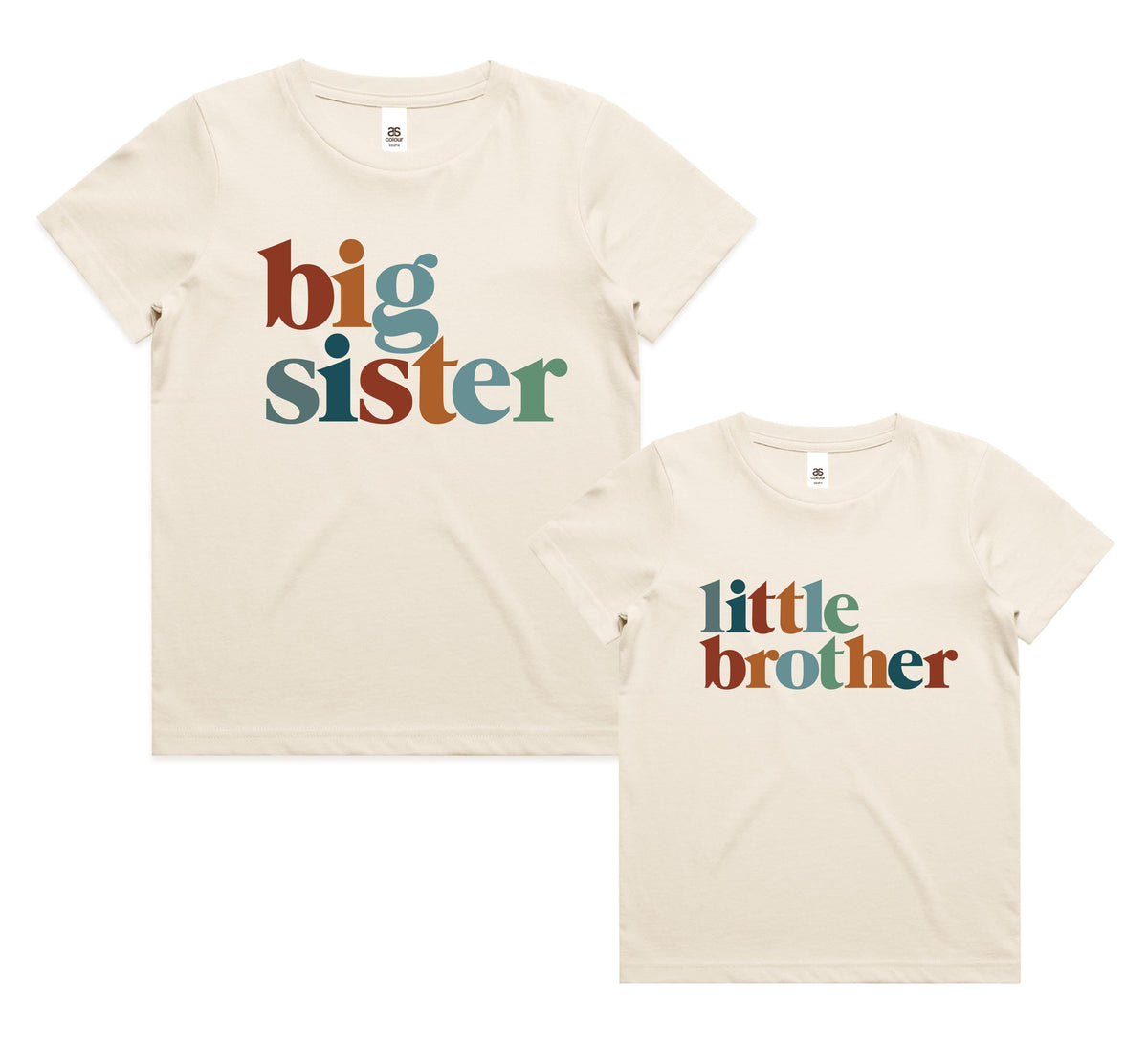 Siblings wearing matching natural cream t-shirts with retro multi-colour lettering reading Big Sister, Little Brother, Big Brother and Little Sister, photographed outdoors in golden afternoon light.