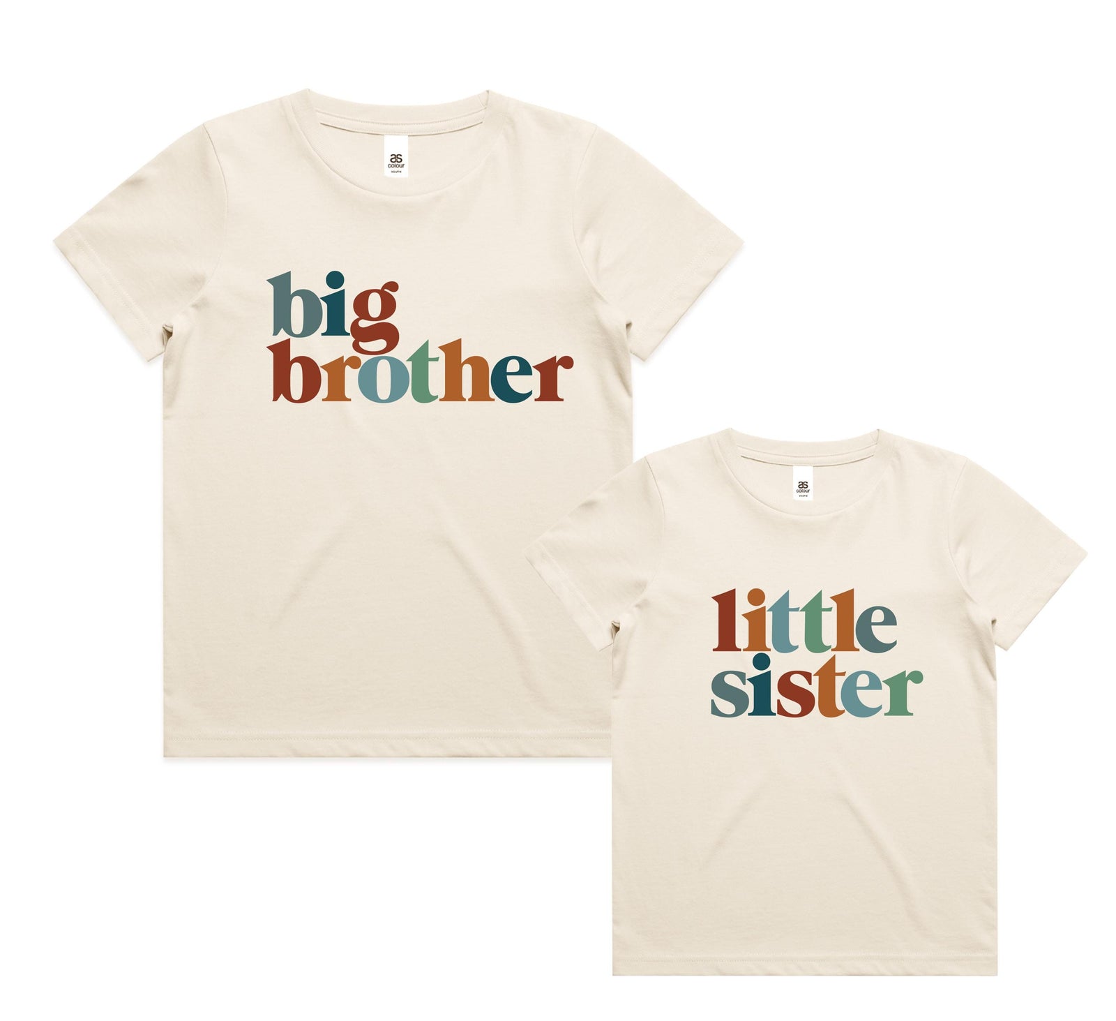 Siblings wearing matching natural cream t-shirts with retro multi-colour lettering reading Big Sister, Little Brother, Big Brother and Little Sister, photographed outdoors in golden afternoon light.