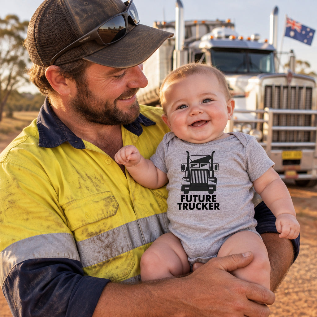 Grey baby bodysuit with a black truck illustration and the words Future Trucker.