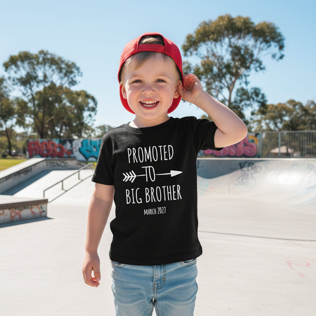 Child wearing Promoted To Big Brother pregnancy announcement shirt outdoors