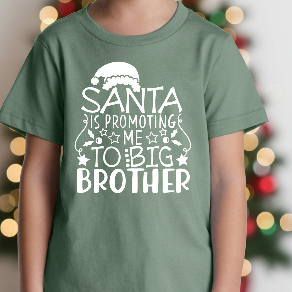Green t-shirt with &#39;Santa is promoting me to big brother&#39; text on a white background