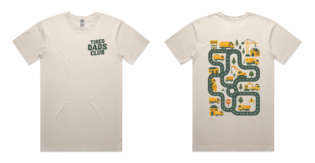 Bone coloured t-shirt with Tired Dads Club on the front and a construction road play map with trucks and cranes on the back.