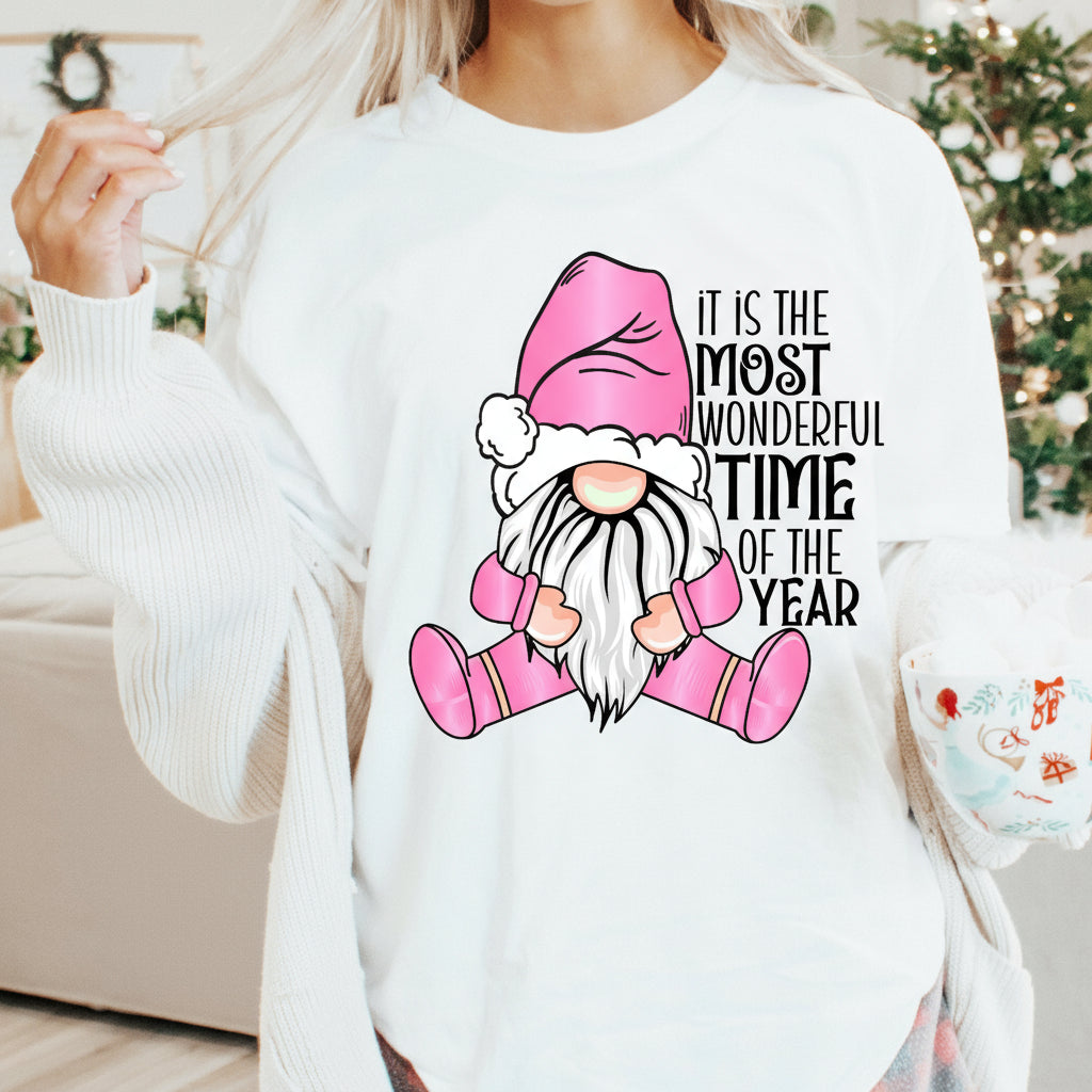 Person wearing a white sweater with a gnome graphic and text in a festive setting.