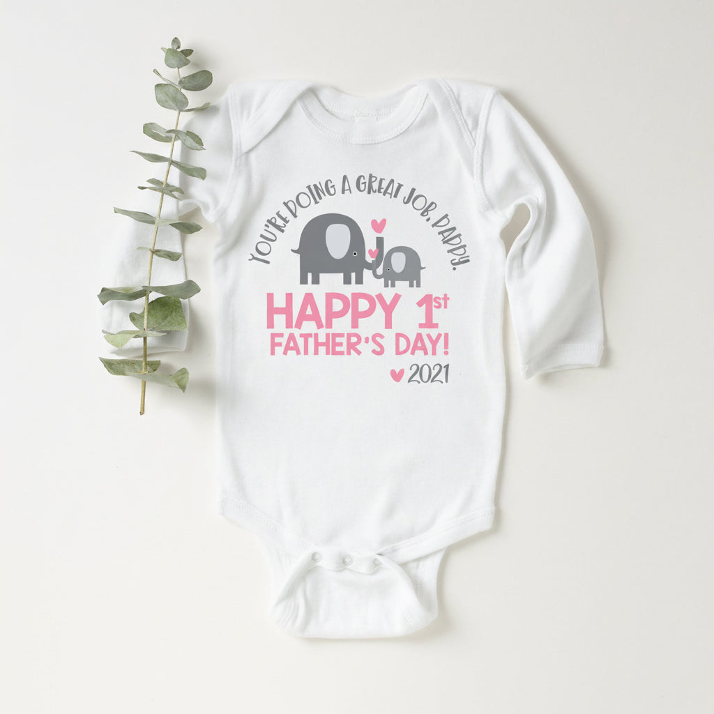 White baby bodysuit with an elephant and calf design reading You're Doing A Great Job Daddy, Happy 1st Father's Day, and the year.