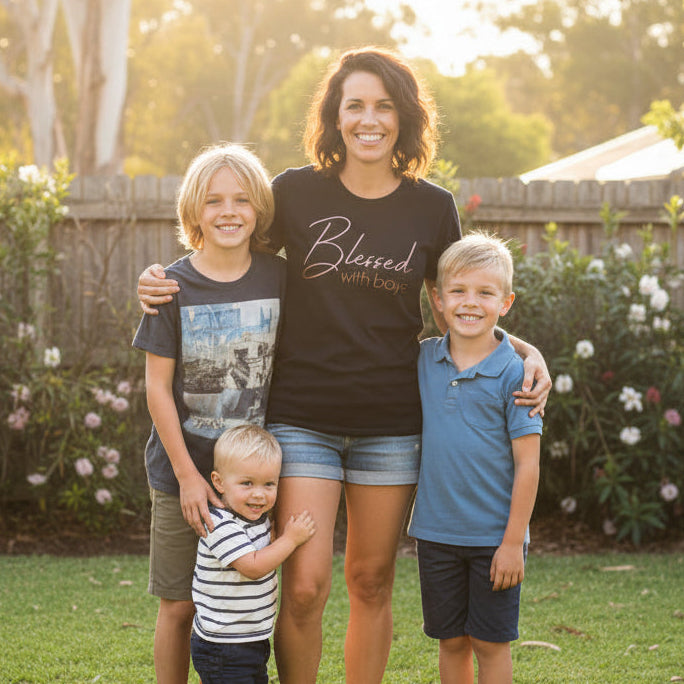 Woman with three children standing in a backyard with green grass and flowers.