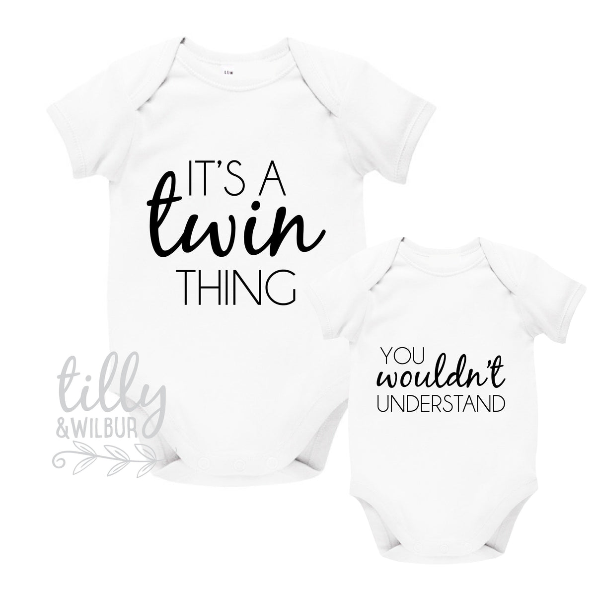 Two white baby bodysuits reading It's a twin thing and you wouldn't understand.