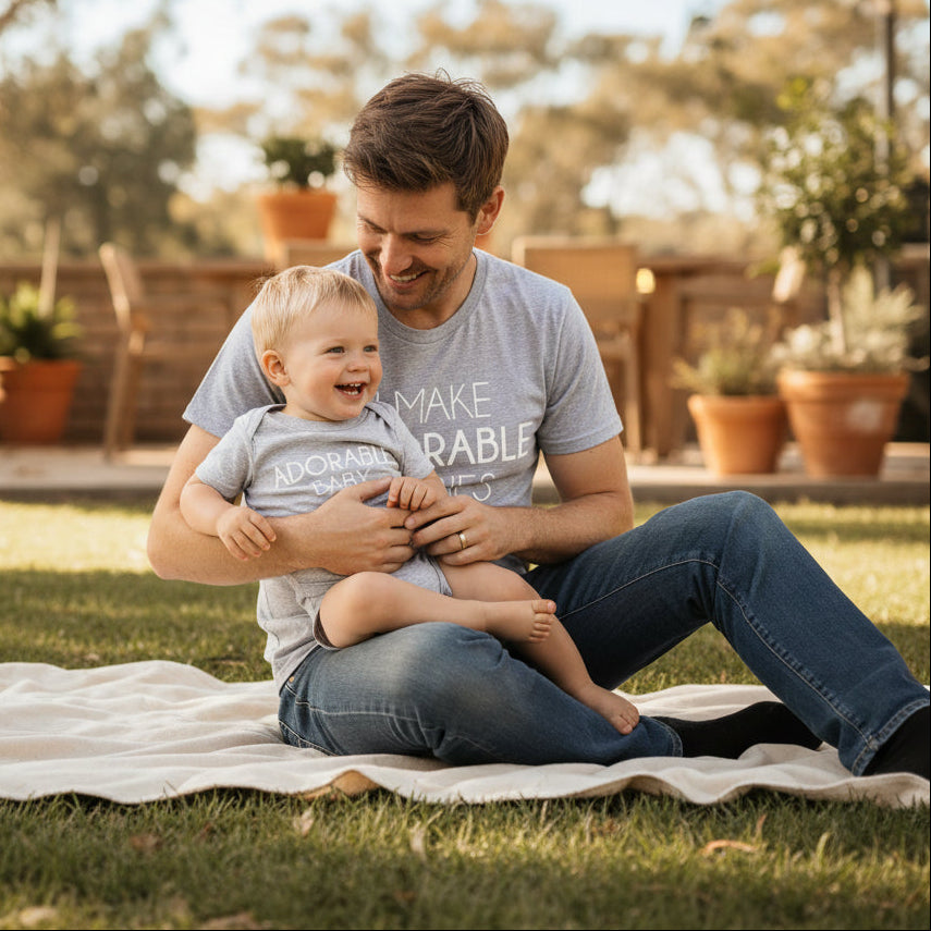 Grey adult t-shirt reading I Make Adorable Babies and grey baby bodysuit reading Adorable Baby.