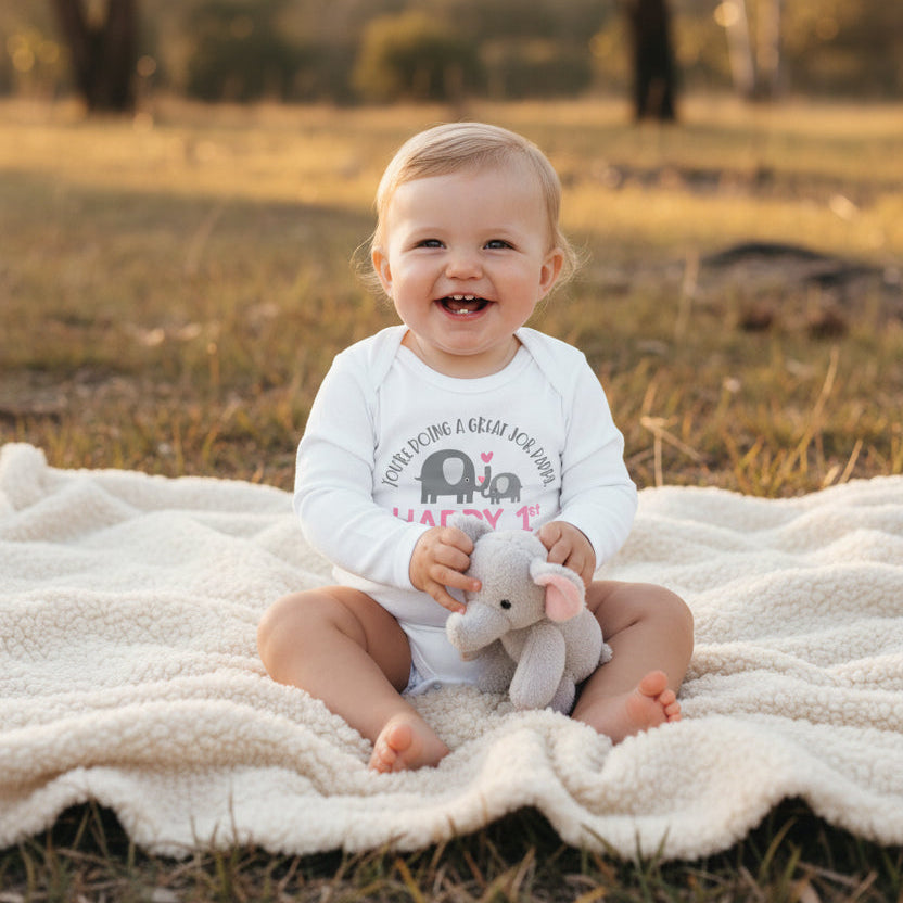 White baby bodysuit with an elephant and calf design reading You're Doing A Great Job Daddy, Happy 1st Father's Day, and the year.